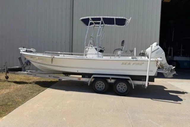 Slide: The Image of 2003 Sea Pro SV2100CC Bay Boat on trailer, parked outside a large building. - 3