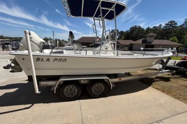 Slide: The Image of 2003 Sea Pro SV2100CC Bay Boat on trailer, parked outdoors under clear sky. - 4