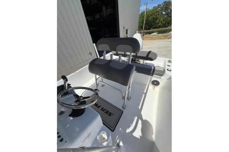 Slide: The Image of 2003 Sea Pro SV2100CC Bay Boat interior with steering wheel and seating. - 8