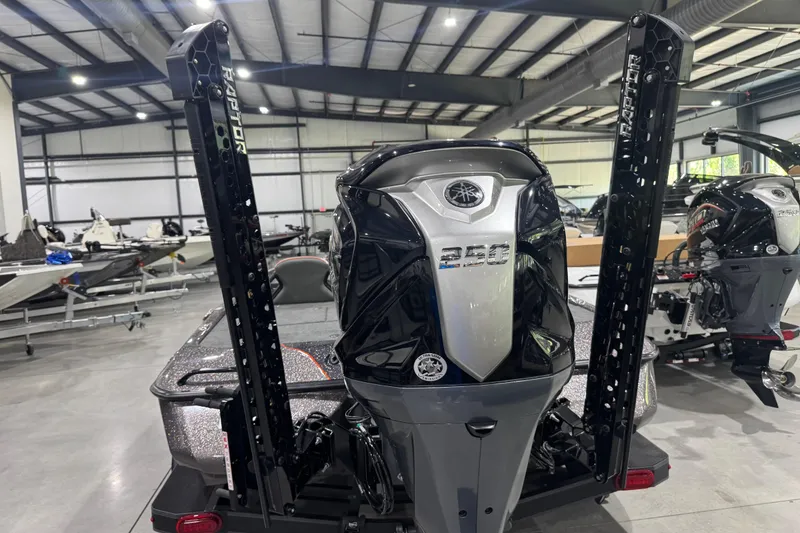 Slide: The Image of 2026 Skeeter ZXE20 boat with powerful 250 engine in showroom setting. - 10