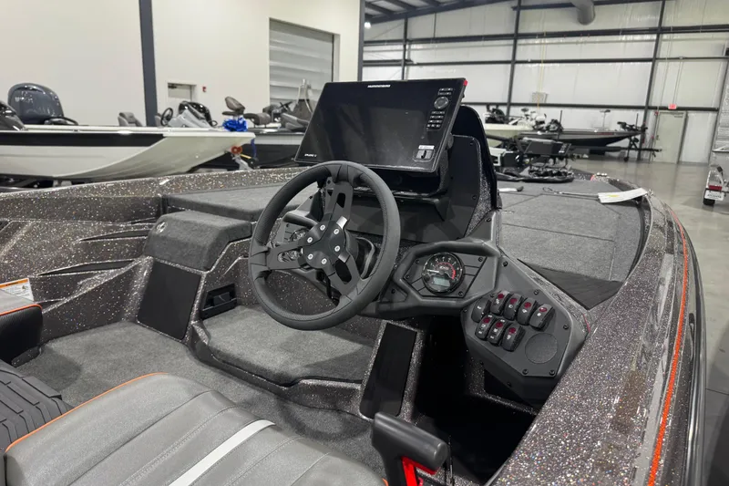 Slide: The Image of 2026 Skeeter ZXE20 boat interior with steering wheel and control panel in showroom. - 11