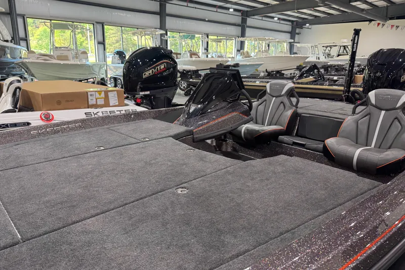 Slide: The Image of 2026 Skeeter ZXE20 boat interior with dual seats and spacious deck in showroom. - 6