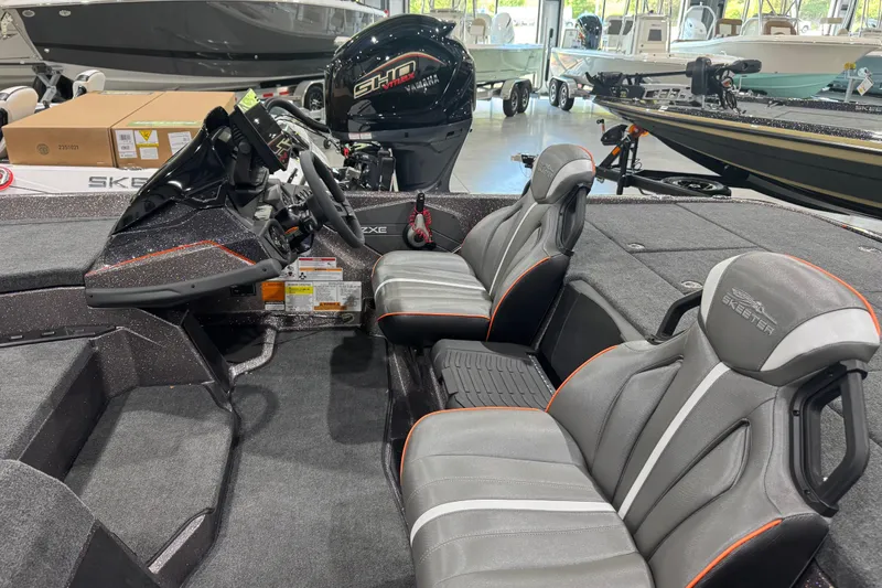 Slide: The Image of 2026 Skeeter ZXE20 boat interior with sleek seats and modern dashboard in showroom. - 7