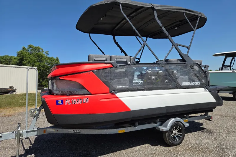 The Image of 2024 Sea-Doo Switch Cruise 18 pontoon boat on trailer, featuring a red and white design. - 0