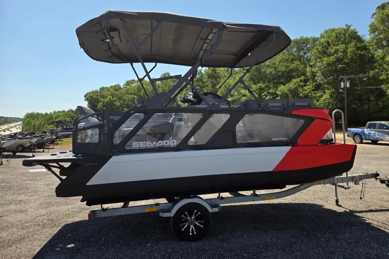Slide: The Image of 2024 Sea-Doo Switch Cruise 18 pontoon boat on trailer, parked outdoors. - 3