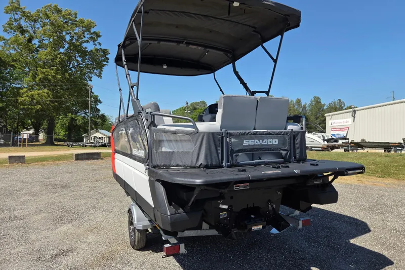 Slide: The Image of 2024 Sea-Doo Switch Cruise 18 pontoon boat on trailer, parked outdoors. - 5