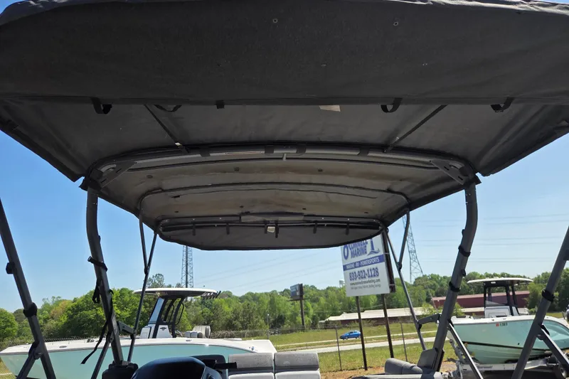 Slide: The Image of 2024 Sea-Doo Switch Cruise 18 canopy view at a dealership. - 6