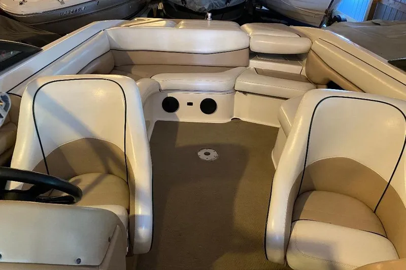Slide: The Image of Interior of a 2001 Malibu Sunscape 25 LSV boat with beige seating. - 13