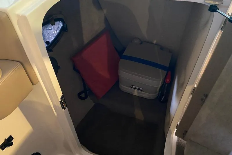 Slide: The Image of Interior storage of 2001 Malibu Sunscape 25 LSV with portable toilet and red cushion. - 17