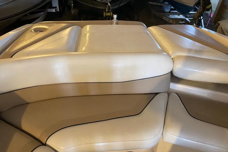 Slide: The Image of Cream leather seating on a 2001 Malibu Sunscape 25 LSV boat interior. - 19
