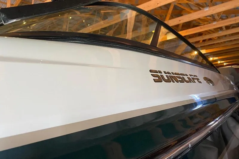 Slide: The Image of 2001 Malibu Sunscape 25 LSV boat in storage, showcasing sleek design and branding. - 2