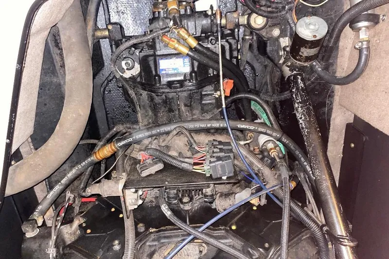 Slide: The Image of Engine compartment of a 2001 Malibu Sunscape 25 LSV boat, showing wiring and components. - 24