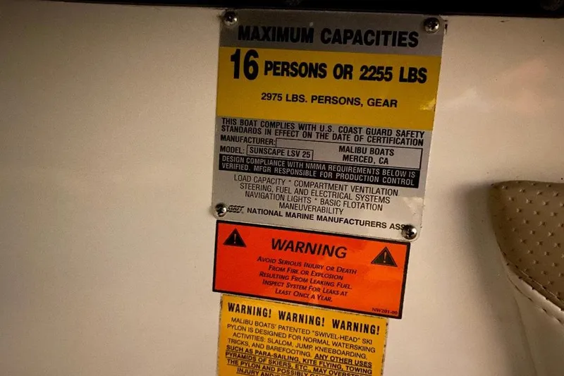 Slide: The Image of Capacity and safety warning labels on a 2001 Malibu Sunscape 25 LSV boat. - 26