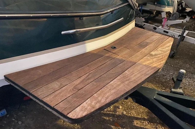 Slide: The Image of 2001 Malibu Sunscape 25 LSV swim platform with wooden finish, parked on a trailer. - 4