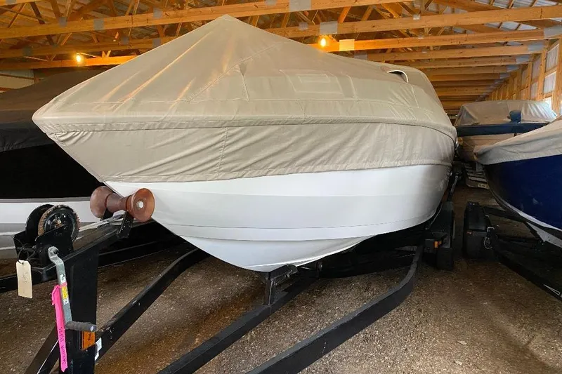 Slide: The Image of Covered 2001 Malibu Sunscape 25 LSV boat stored indoors on a trailer. - 6