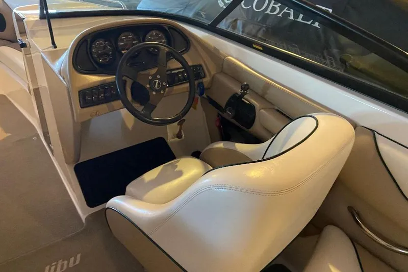 Slide: The Image of 2001 Malibu Sunscape 25 LSV boat interior with steering wheel and dashboard controls. - 9