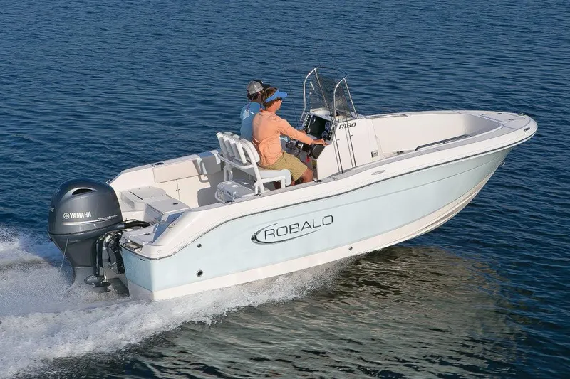 Slide: The Image of 2026 Robalo R180 Center Console boat on trailer, side view. - 3