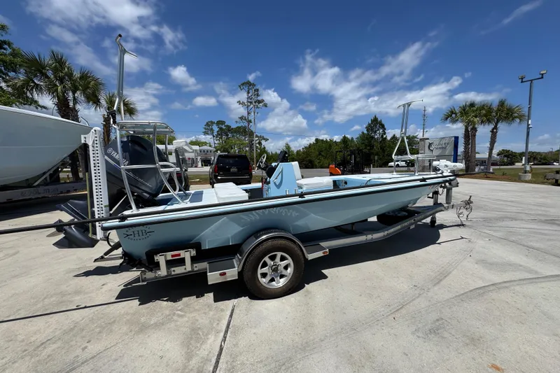 Slide: The Image of 2016 Hell's Bay Marquesa boat on trailer under clear blue sky. - 10