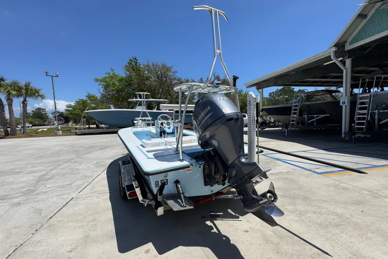 Slide: The Image of 2016 Hell's Bay Marquesa boat with Yamaha outboard motor in a sunny marina. - 15