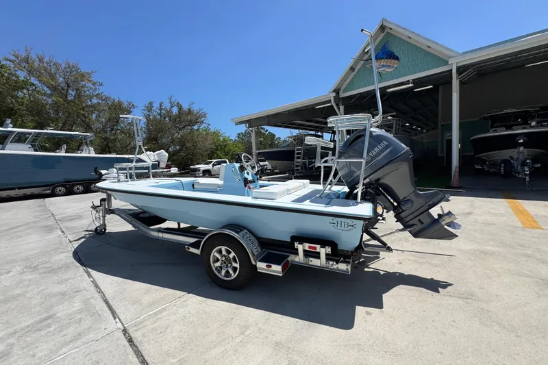 Slide: The Image of 2016 Hell's Bay Marquesa boat on trailer, parked outside a boat storage facility. - 17