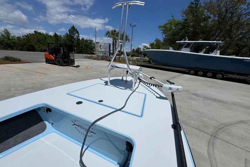 Slide: The Image of 2016 Hell's Bay Marquesa boat on display in a parking lot with clear skies. - 18