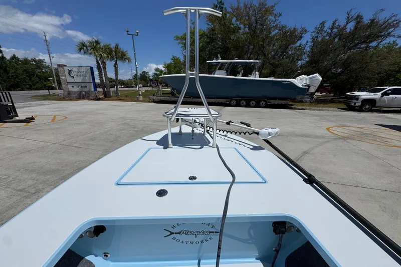 Slide: The Image of 2016 Hell's Bay Marquesa boat in a parking lot with palm trees and clear sky. - 19