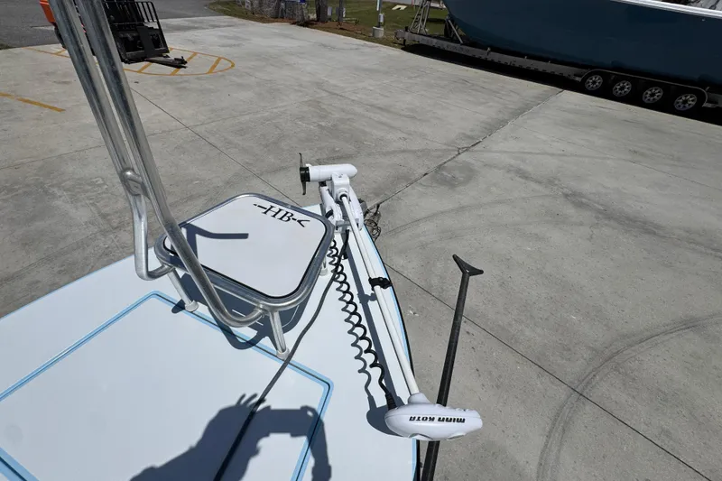 Slide: The Image of 2016 Hell's Bay Marquesa boat with Minn Kota trolling motor on concrete surface. - 21