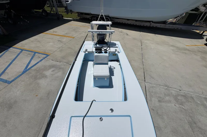 Slide: The Image of 2016 Hell's Bay Marquesa boat on trailer, viewed from above in a parking area. - 24