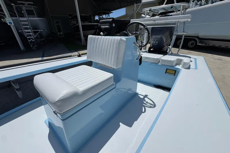 Slide: The Image of 2016 Hell's Bay Marquesa boat interior with white seating and steering console. - 26
