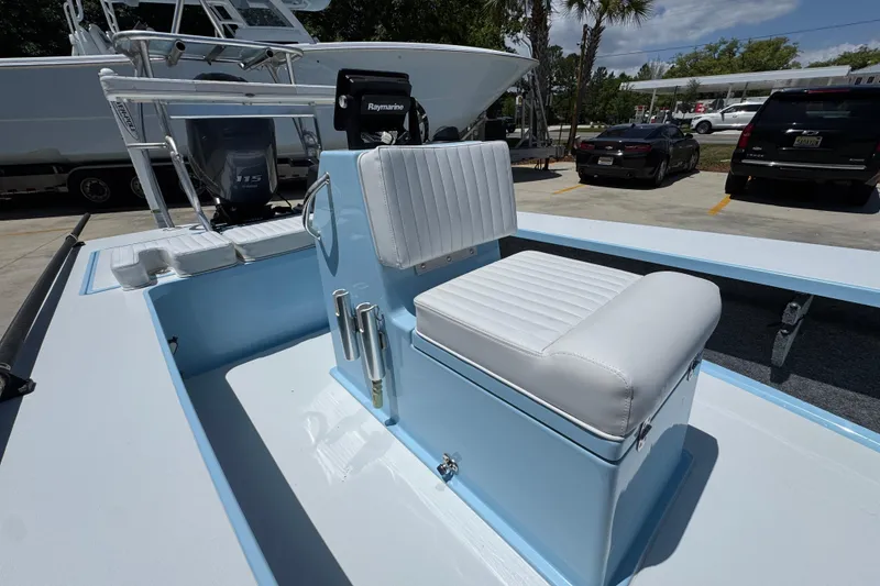 Slide: The Image of 2016 Hell's Bay Marquesa boat interior with white seating and Raymarine equipment. - 27