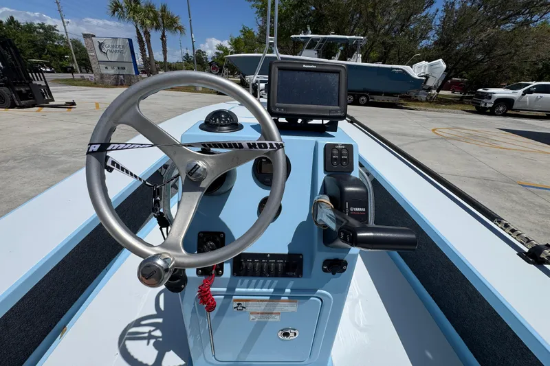 Slide: The Image of 2016 Hell's Bay Marquesa boat console with steering wheel and navigation equipment. - 29