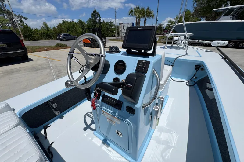 Slide: The Image of 2016 Hell's Bay Marquesa boat console with steering wheel and navigation equipment. - 30