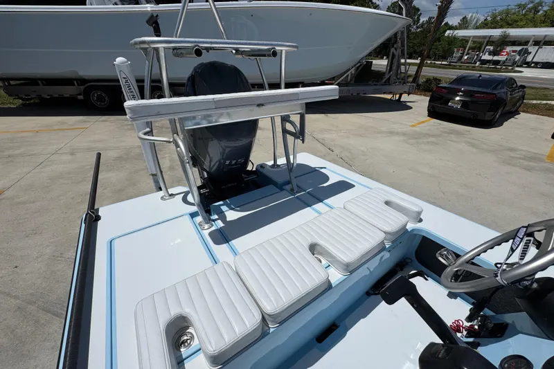 Slide: The Image of 2016 Hell's Bay Marquesa boat with Yamaha 175 engine, parked outdoors. - 33
