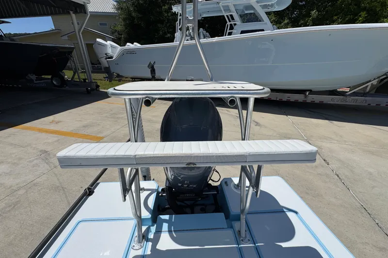 Slide: The Image of 2016 Hell's Bay Marquesa boat with dual seating and motor, parked outdoors. - 34