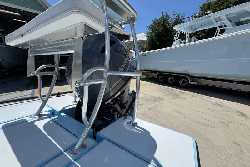 Slide: The Image of 2016 Hell's Bay Marquesa boat with Yamaha outboard motor, parked near a trailer. - 37