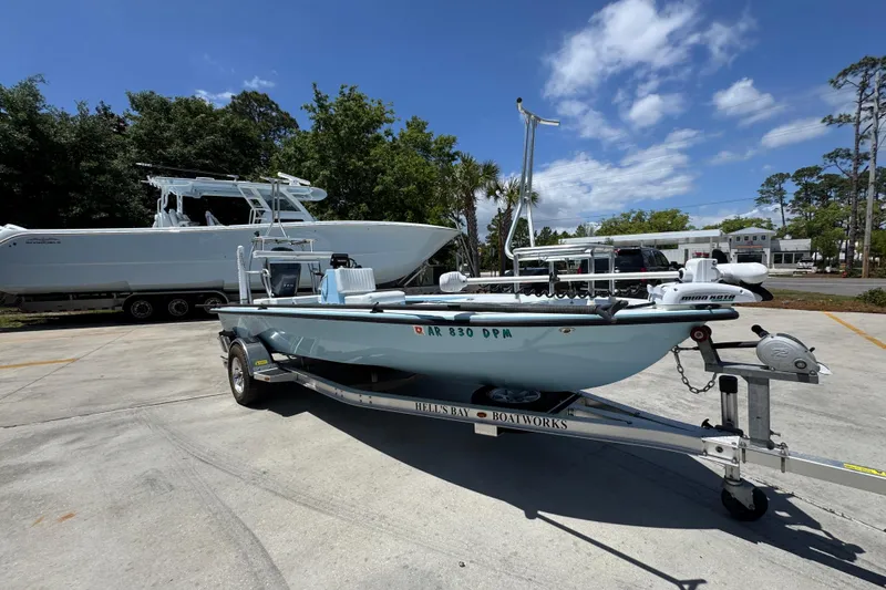 Slide: The Image of 2016 Hell's Bay Marquesa boat on trailer, parked outdoors under a clear sky. - 7