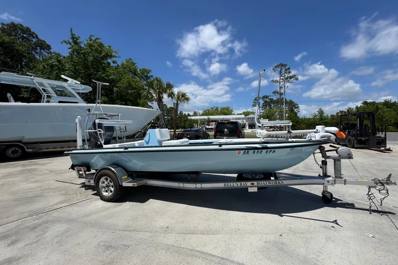 Slide: The Image of 2016 Hell's Bay Marquesa boat on trailer under clear blue sky. - 8