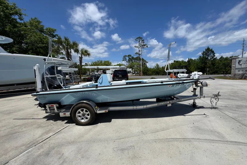 Slide: The Image of 2016 Hell's Bay Marquesa boat on trailer under clear blue sky. - 9