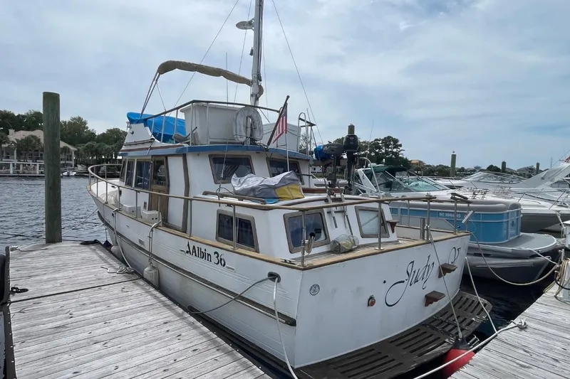 The Image of 1979 Albin 36 Trawler docked at marina, featuring classic design and spacious deck. - 1