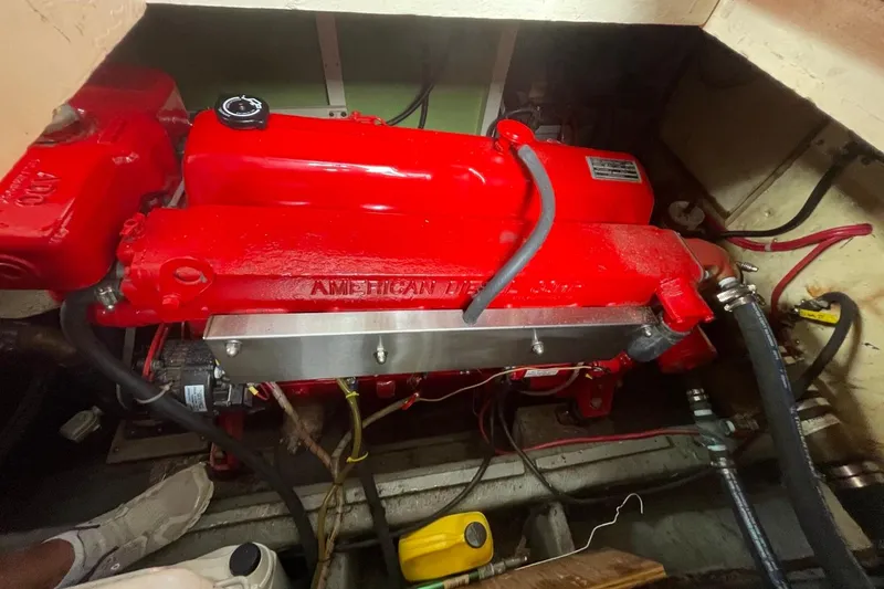Slide: The Image of Engine compartment of a 1979 Albin 36 Trawler with a red American Diesel engine. - 12