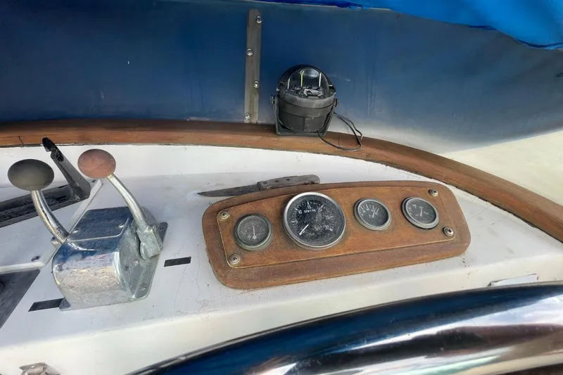 Slide: The Image of 1979 Albin 36 Trawler dashboard with gauges and controls, featuring a wooden panel. - 18
