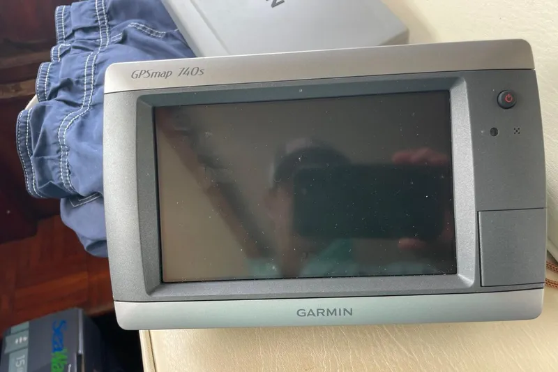 Slide: The Image of Garmin GPSmap 740s device on Albin 36 Trawler, 1979 model, with blue shorts nearby. - 19