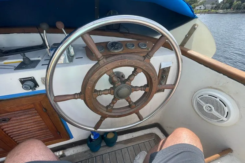 Slide: The Image of Steering wheel of a 1979 Albin 36 Trawler, showcasing classic nautical design. - 7