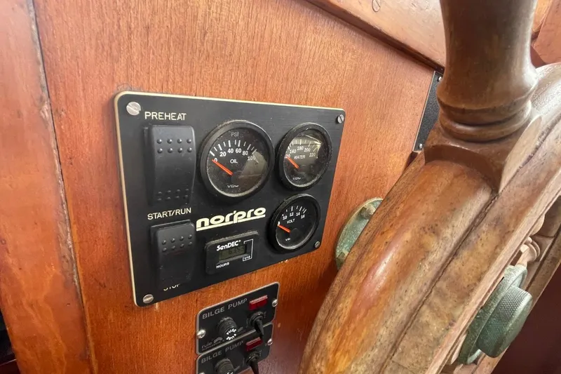 Slide: The Image of Control panel and wooden wheel of a 1979 Albin 36 Trawler boat. - 8