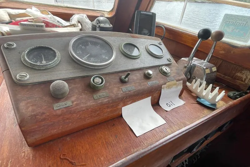 Slide: The Image of 1979 Albin 36 Trawler dashboard with vintage gauges and controls. - 9