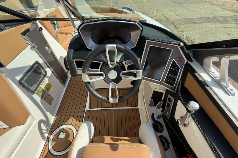 Slide: The Image of 2020 MasterCraft X22 boat cockpit with modern steering and control panel. - 11