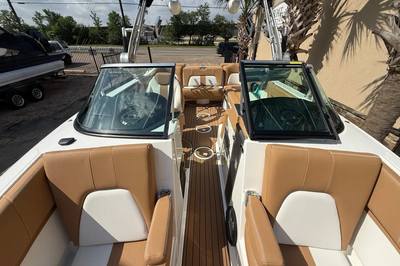 Slide: The Image of 2020 MasterCraft X22 boat interior with tan and white seating, sleek design. - 14