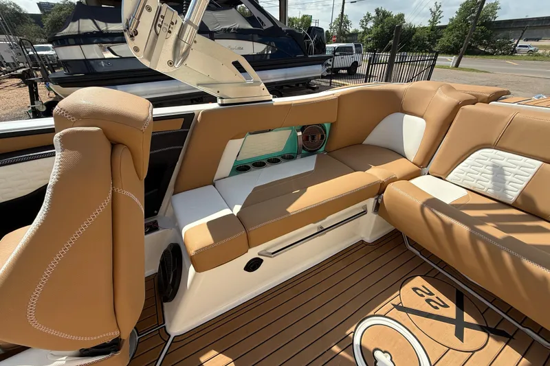 Slide: The Image of 2020 MasterCraft X22 boat interior with tan leather seating and teak flooring. - 15