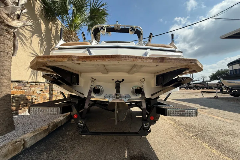 Slide: The Image of Rear view of a 2020 MasterCraft X22 boat on a trailer, under a sunny sky. - 7