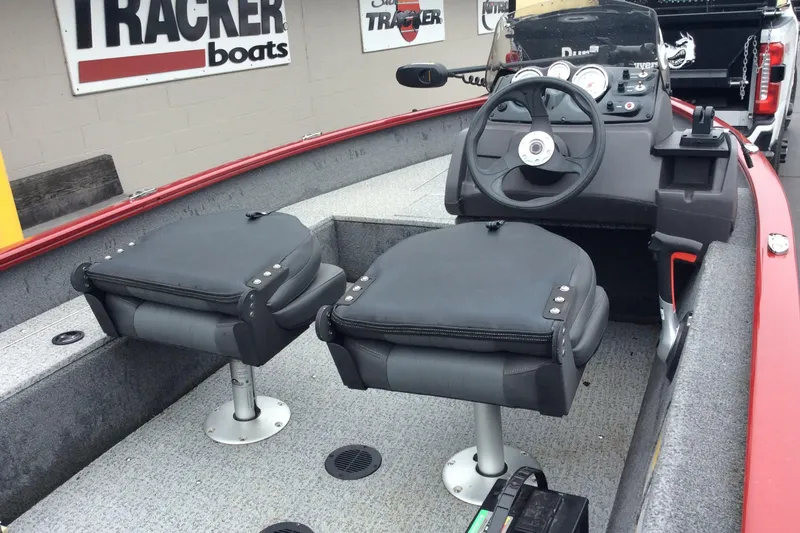 Slide: The Image of 2021 Tracker Super Guide V-16 SC boat interior with steering console and seating. - 3